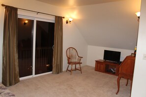 Futon area desk, rear balcony and television with VCR