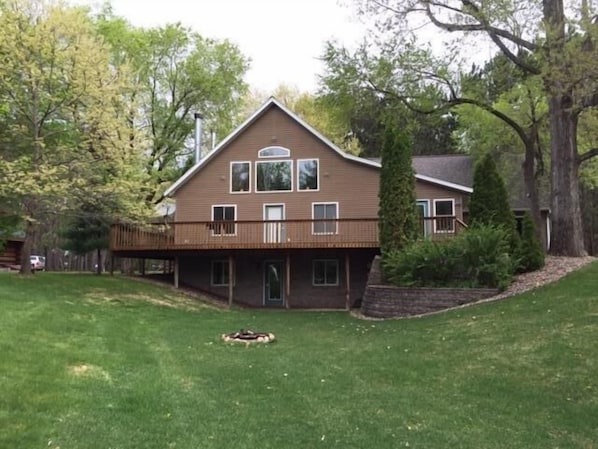 View of backyard of Lodge.  Shows firepit, walkout basement