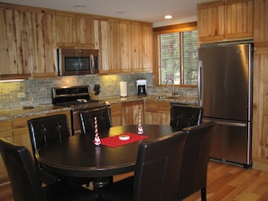 Kitchen with all new stainless steel appliances and expandable table to seat 8.