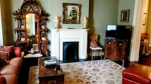 Living Room with leather sofa / chair / ottoman / TV / DVD