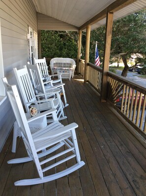 Rockers and glider line the spacious covered front porch.