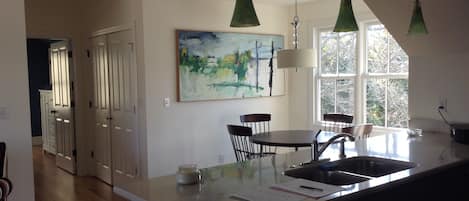 View from kitchen into dining area and hall to bedroom.  Lots of natural light.