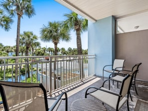 Spacious balcony with new furniture overlooking pond and pool off to the right