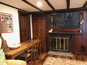 dining/ work table, fireplace, TV with FIOS, closet