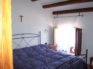 master bedroom with window looking out onto Mediterranean