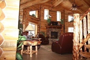 Great Room from front entry...rock gas fireplace...high vaulted ceilings