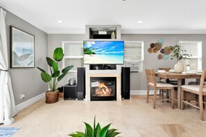 Enjoy the pleasure of dining in an open living space with a smart Tv plus surround sound entertainment center
