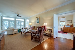 Light filled living room with views to porch, expansive yard & marsh.