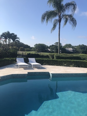 Private pool with sun chairs