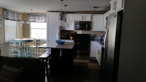 Full kitchen area and dining area