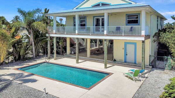 Grill and dining area adjoining poolroom and heated pool.