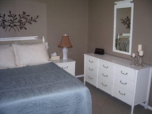 Master bedroom with attached bath features a queen bed.