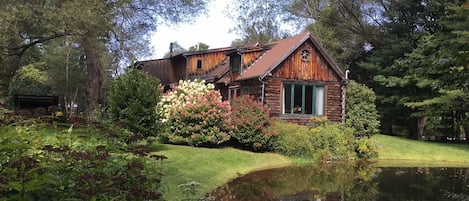 Unique log home perched above a pond, surrounded by stunning gardens & orchard