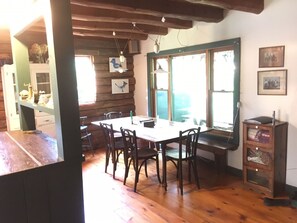 Farm table with a bench and chairs easily sits family and friends