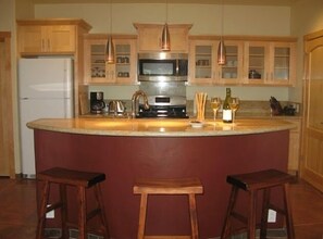 Well stocked kitchen with granite counter tops. 