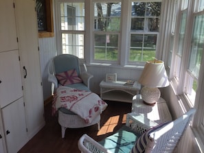 Enclosed front porch perfect place to read and relax.