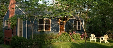 Front of cottage, grill on side deck, lawn and cherry trees