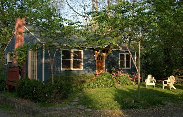 Front of cottage, grill on side deck, lawn and cherry trees