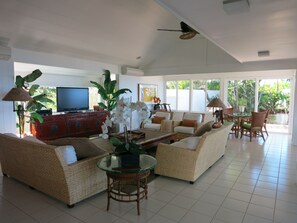 Living room - plenty of seating, big screen TV, and AC
