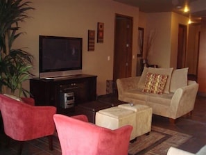 Modern comfortable furnishings and flat screen TV.