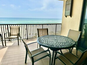 Balcony features sturdy table to sit at while enjoying the ocean breeze.