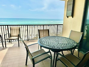 Balcony features sturdy table to sit at while enjoying the ocean breeze.