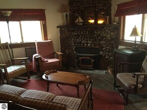 Wood burning fireplace, cozy living room, and mostly craftsman furniture.