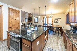 Open floor plan. Kitchen flows to dining area to living area.