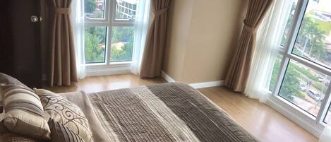 Bedroom with floor to ceiling windows.