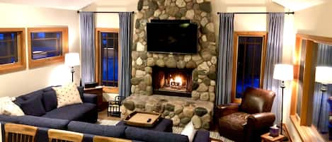 Comfortable Living Space with Stone Fireplace and Vaulted Ceiling