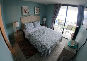 Master Bedroom with balcony access and 55" Smart TV.