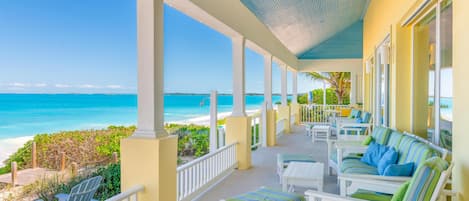 The beachfront covered verandah creates a breathtaking outdoor living room.