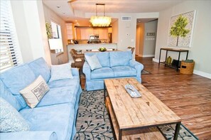 Living room, 42' HD tv is to the right on the wall above a fireplace. Balcony