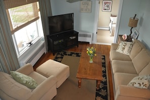 birds eye shot, bright and airy family room.  breeze way room visible in corner