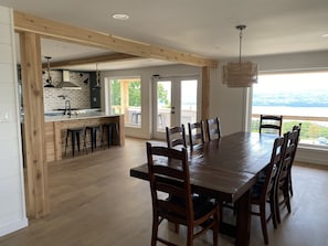 Open concept dining/kitchen with deck doors to grill