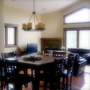 Dining room with pub style table and enough for 8 at the table