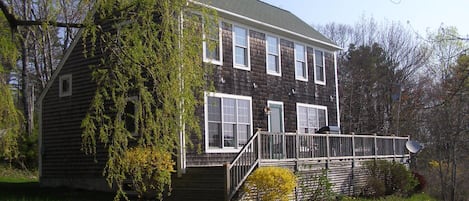 Front of the house with deck and gas grill