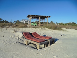 View from beach north to house.  Beach chairs and beach hut with bed 