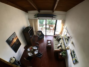 Living room & dining area with a/c & lanai. Surfboards in pic not for guest use.