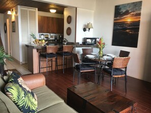 Living room and dining area with air conditioning & lanai access.
