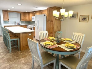Dining area with updated kitchen, including quartz countertop and island seating