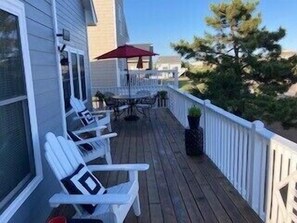 Deck facing the ocean with table/umbrella, seating for 4, 2 Adirondack chairs.