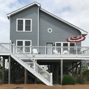 Back of the house facing the ocean. Brand new siding, paint, and windows.