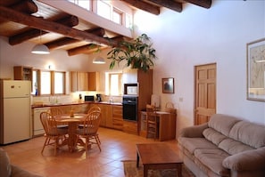 Fully equipped kitchen and dining area, opens into living room, big bright space