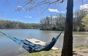 Relax on hammack, our floating dock with swim ladder shown in background.