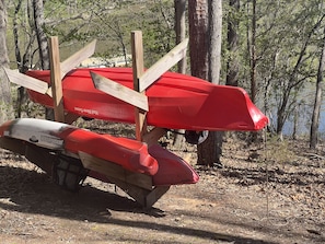 Canoe and Kayak stand near lake.