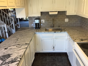 New granite counter top and tile backsplash