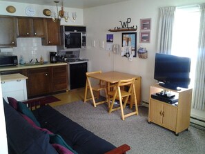 Drop-leaf table, 4 chairs, oven, stove top, dishwasher, microwave & coffeemaker.