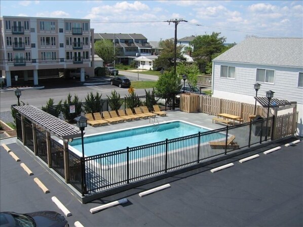 View of pool and grill area from condo