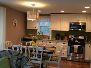 Brand new, well-stocked kitchen includes granite counter & stainless appliances